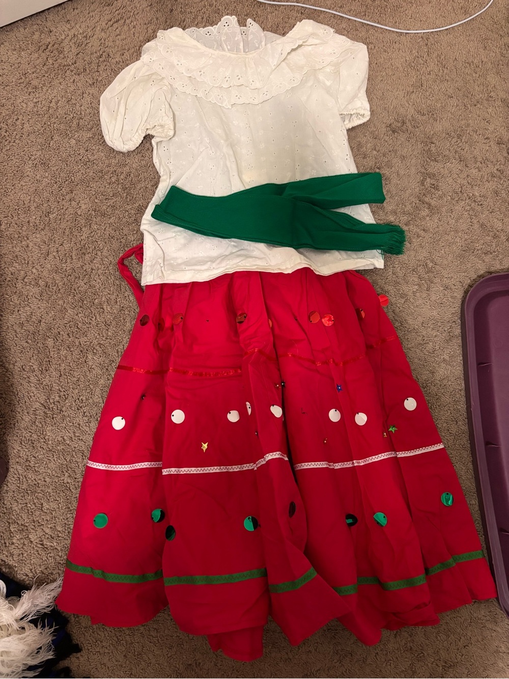 Folclórico Red skirt with white polka dots and green trim, with a white top and